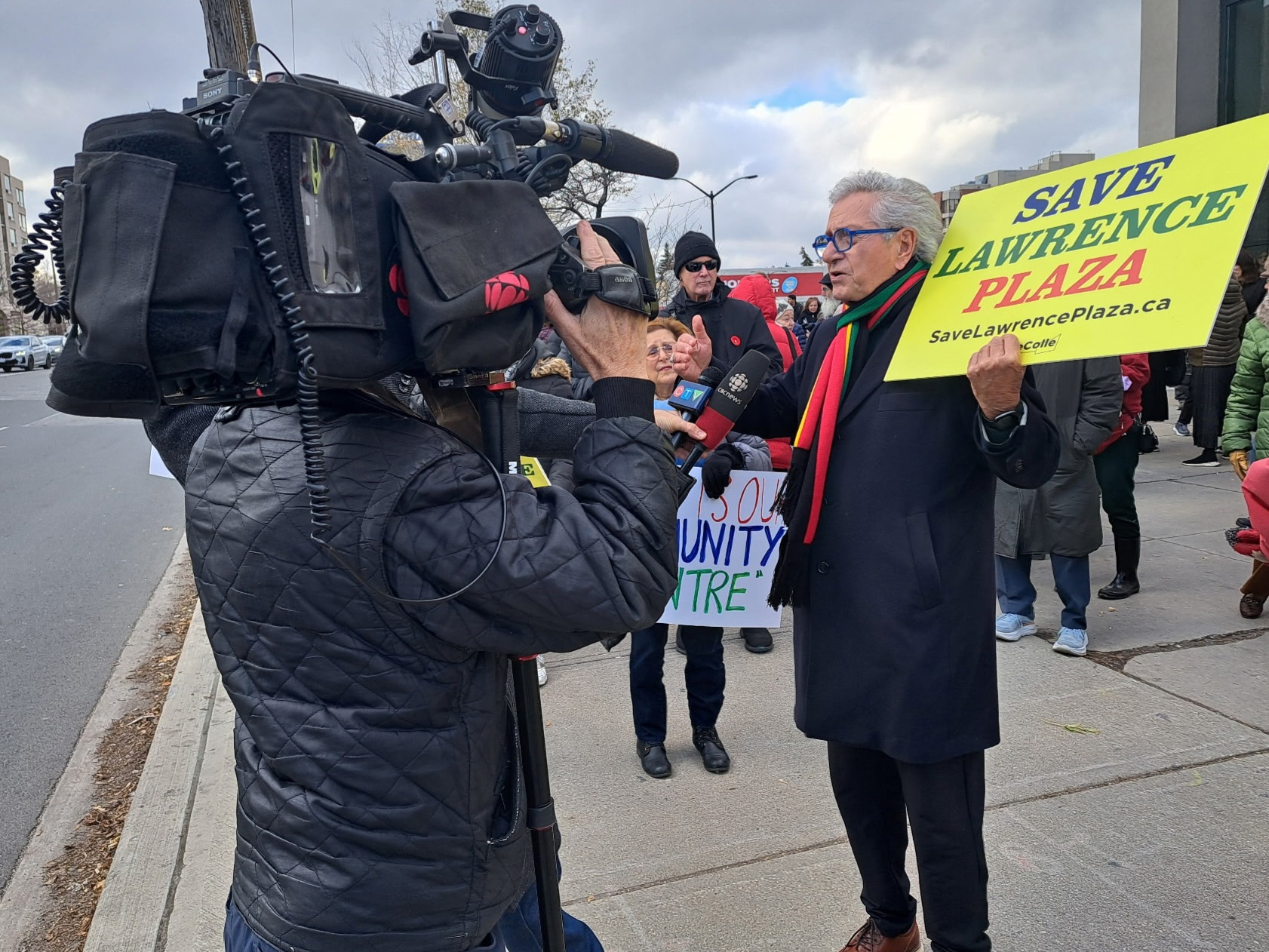 Mike Colle speaking with residents outside Lawrence Plaza